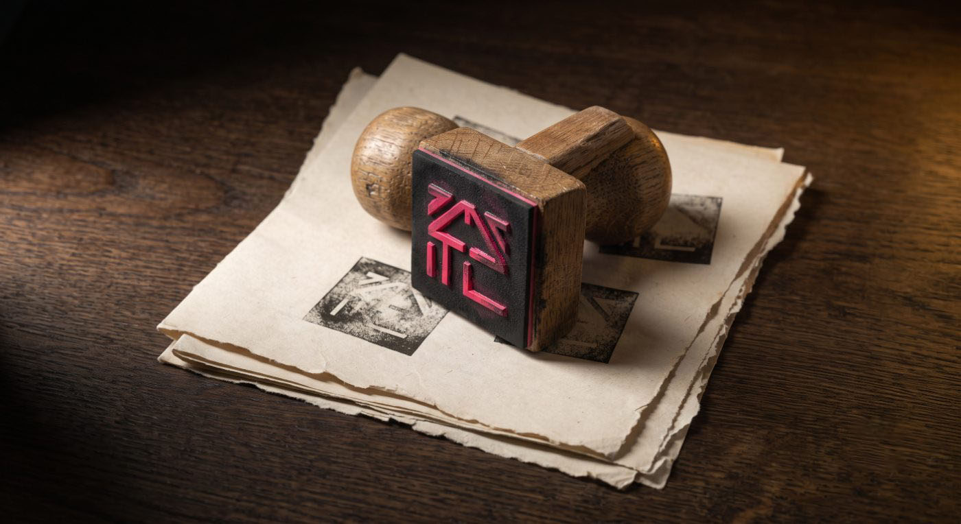 The WAKE rubber stamp resting on a stack of stamped paper
